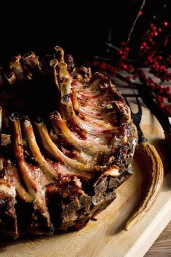 Une photo d'une couronne de longe de porc en glaçage royal avec sauce